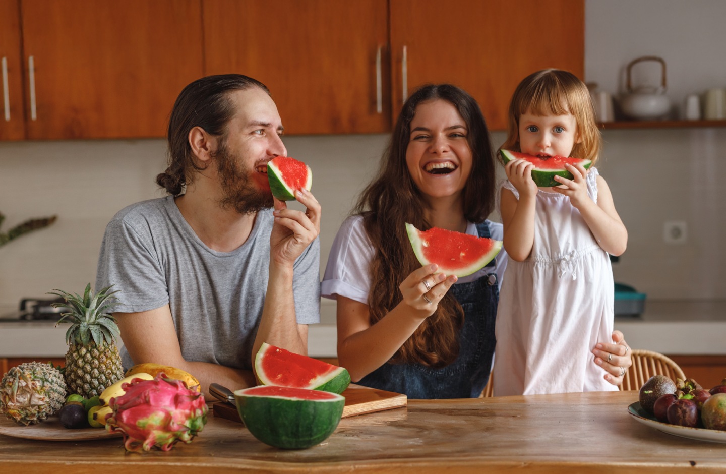 Família com uma criança a comer melancia