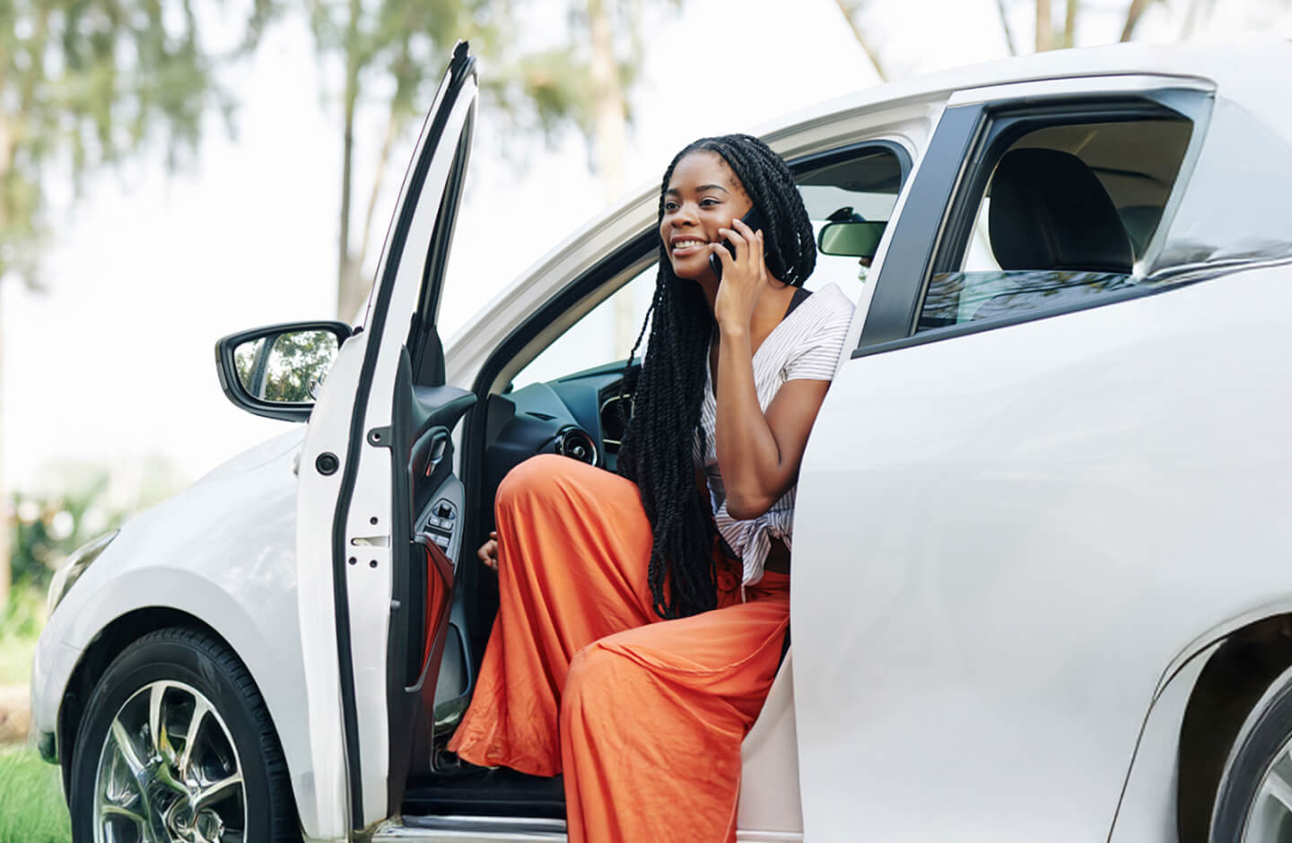 Mulher fala ao telemóvel no carro