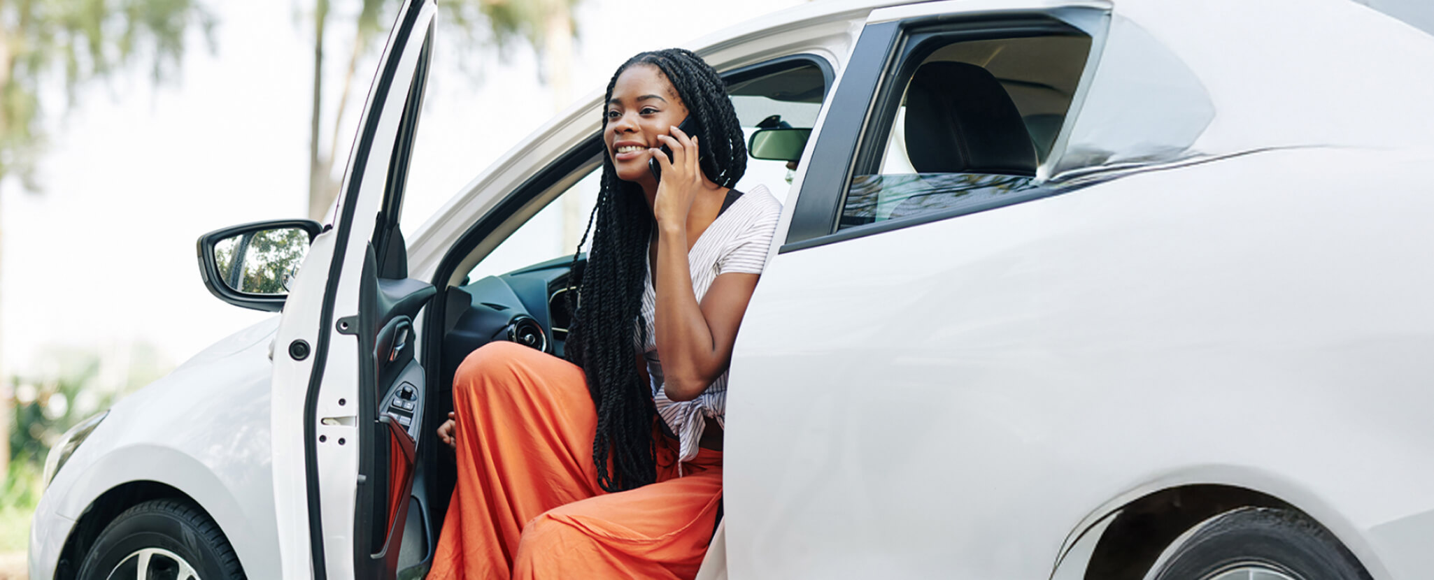 Mulher fala ao telemóvel no carro