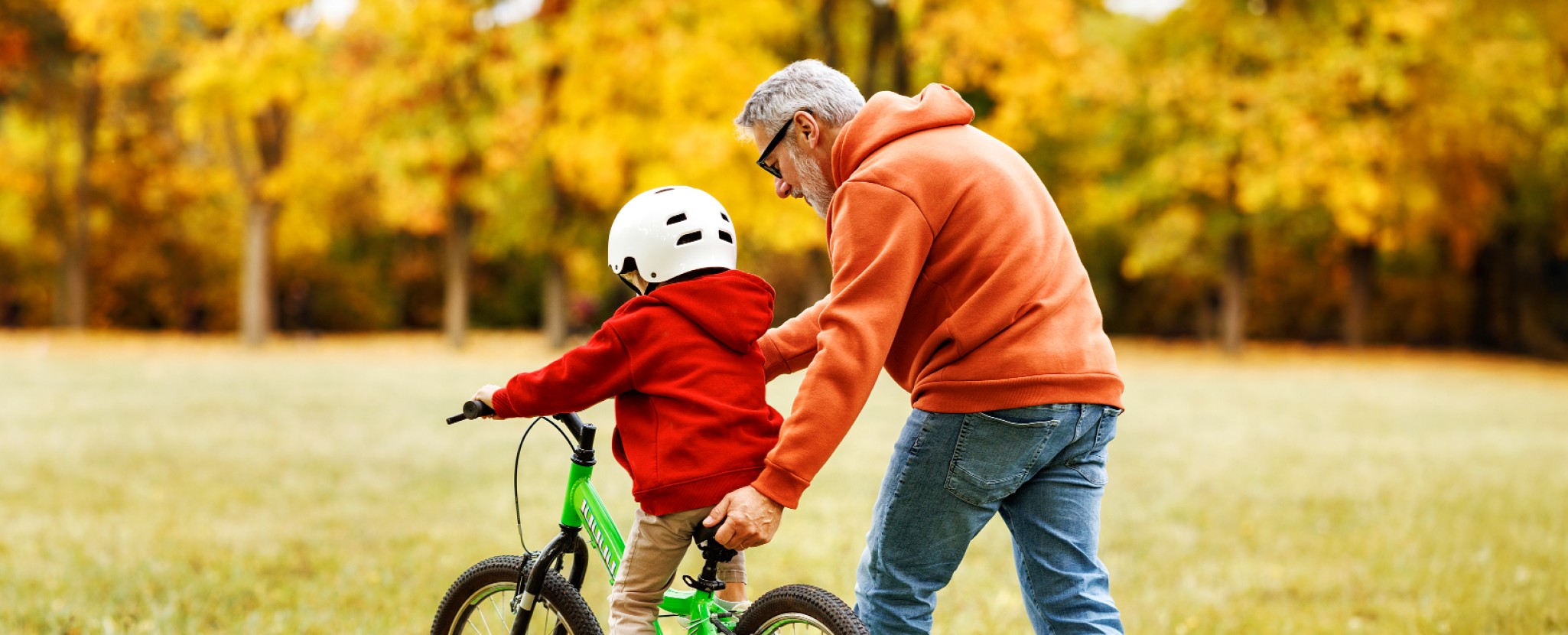Pai ensina filho a andar de bicicleta