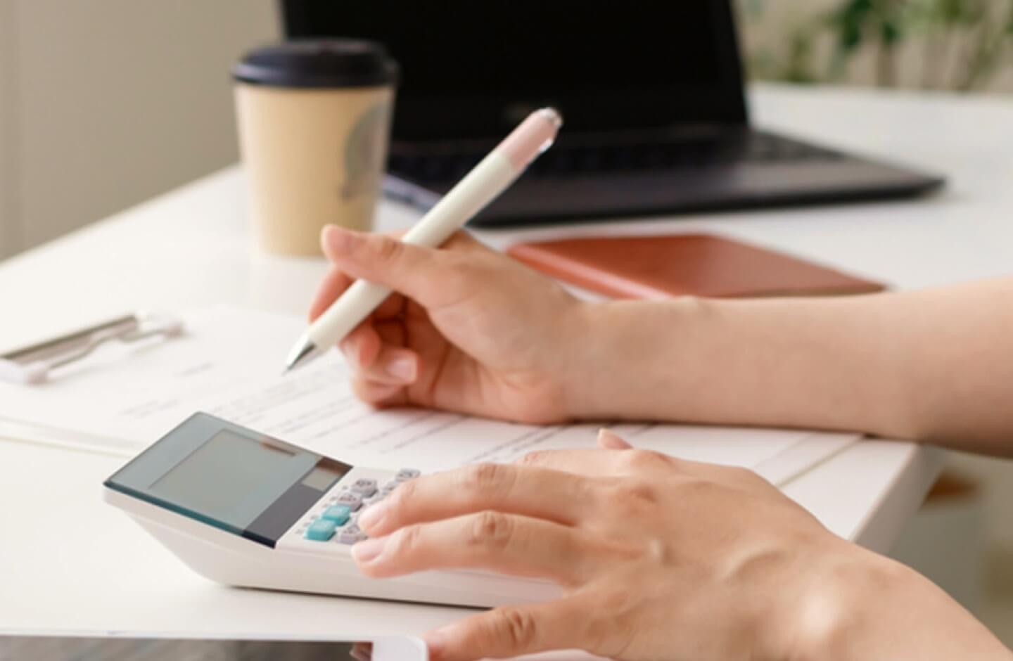 Pessoa entrega IRS recorrendo a calculadora, papel e caneta