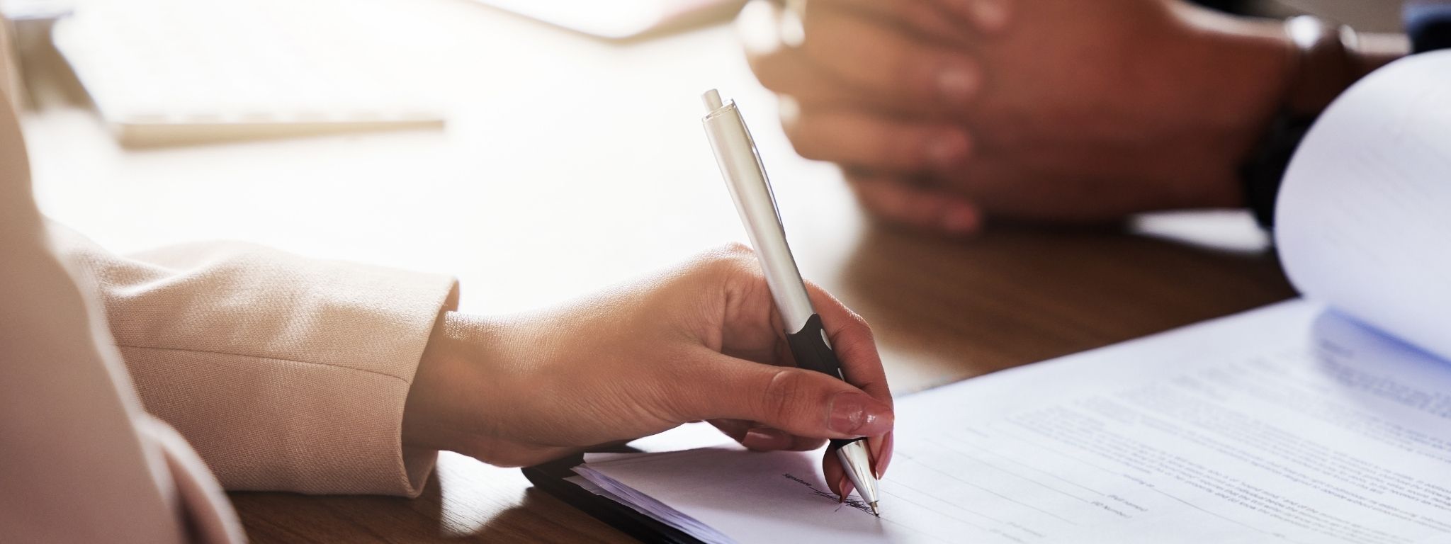 duas pessoas a assinar um contrato de compra e venda