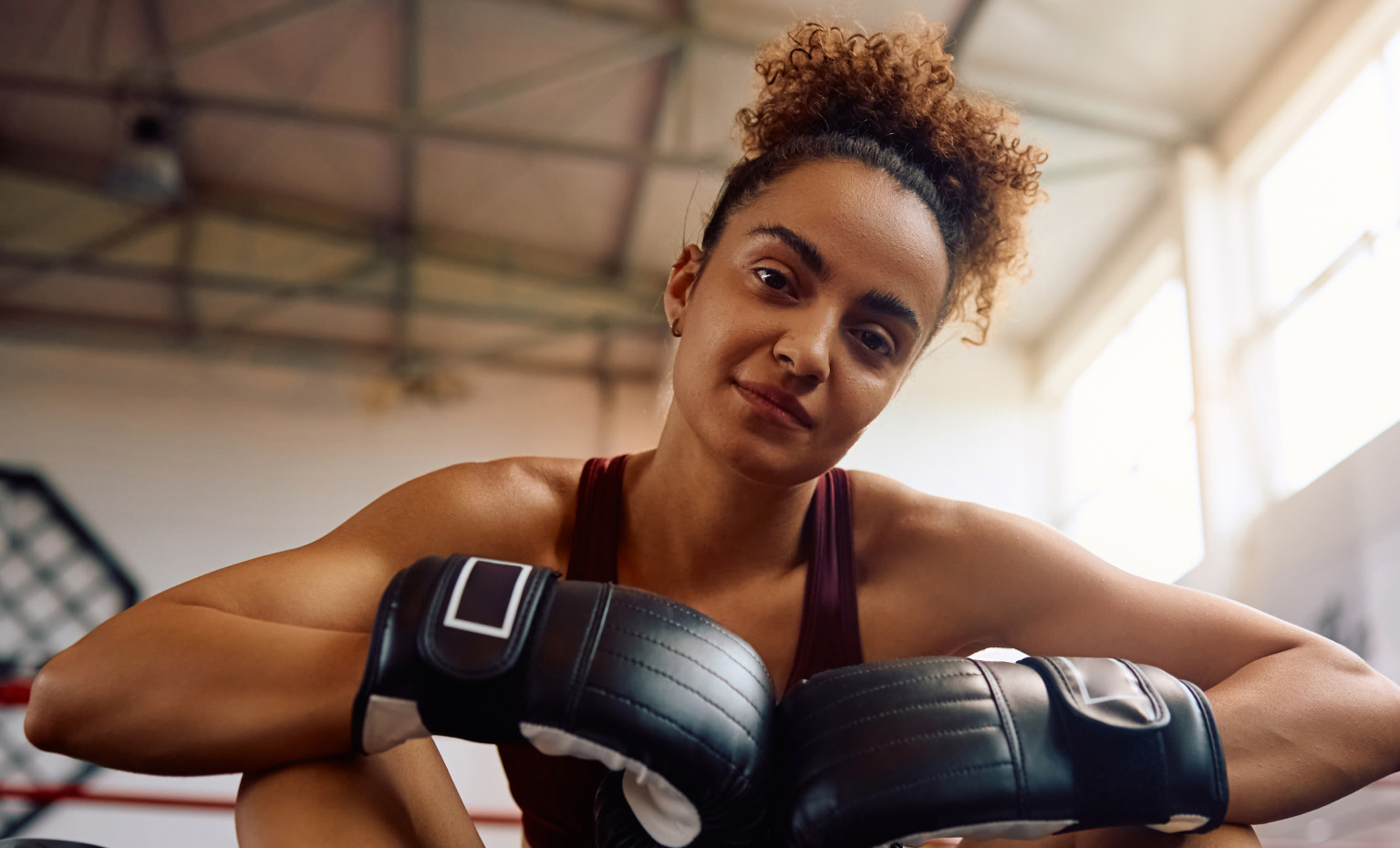 jovem mulher com luvas de boxe calçadas